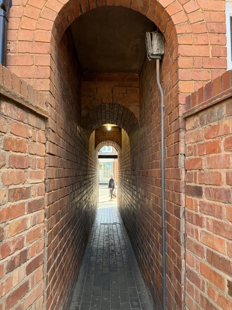 A narrow brick alleyway leading through to Regent Street.